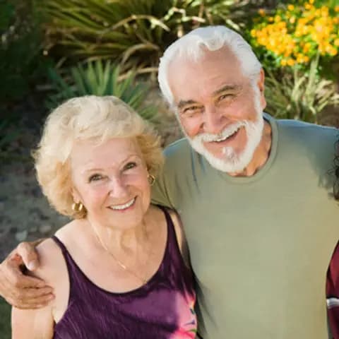 Three generations of a family smiling together